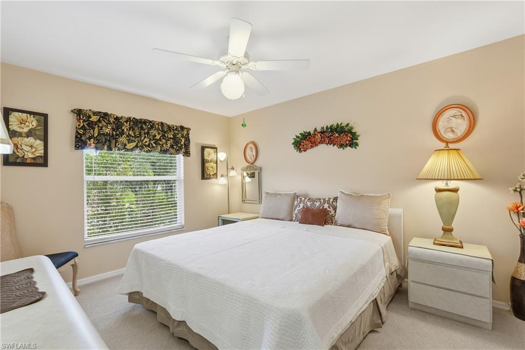 8055 Tiger Cove, Unit 608 Naples, FL 34113 - Photo 13 of 21 a bedroom with a bed and a window