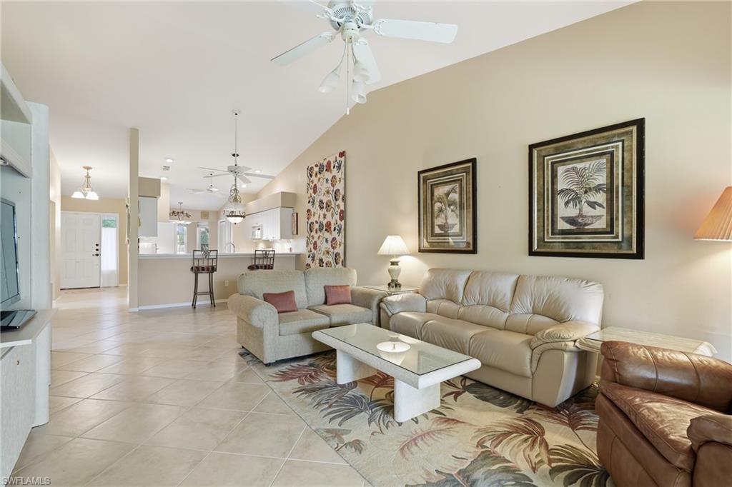 8055 Tiger Cove, Unit 608 Naples, FL 34113 - Photo 18 of 21 a living room with furniture and a chandelier