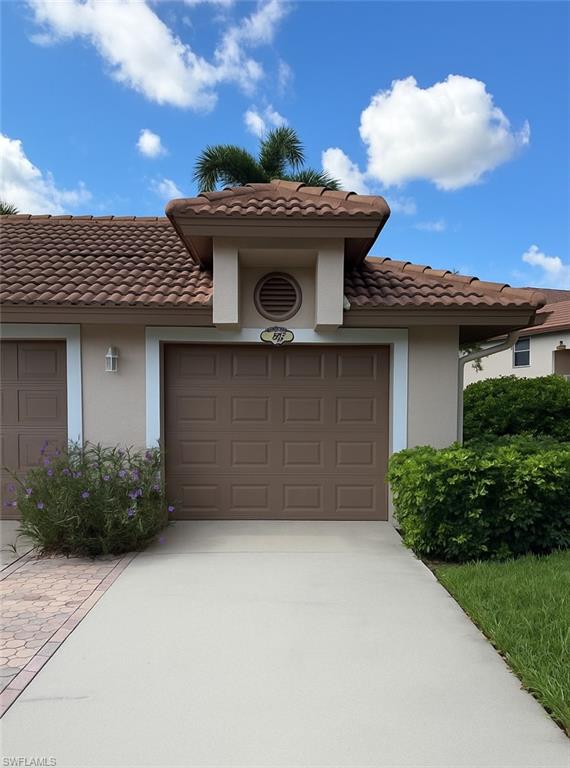 8055 Tiger Cove, Unit 608 Naples, FL 34113 - Photo 21 of 21 a front view of a house with a garden