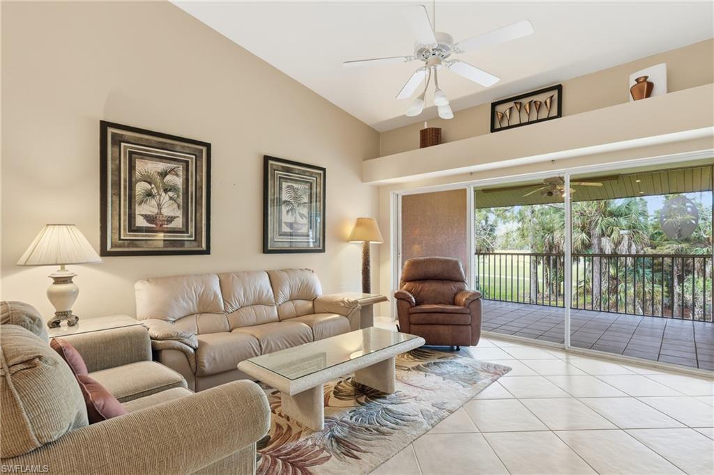 8055 Tiger Cove, Unit 608 Naples, FL 34113 - Photo 10 of 21 a living room with furniture and a large window