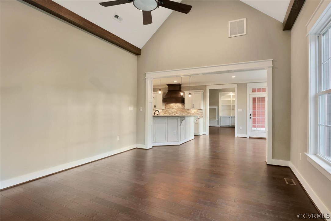 9201 Barrows Ridge Court Chesterfield, VA 23838 - Photo 15 of 35 an empty room with wooden floor and a kitchen