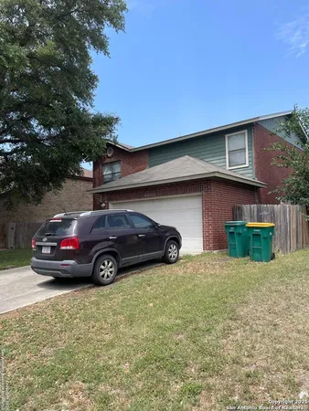 a view of a car in front of a house