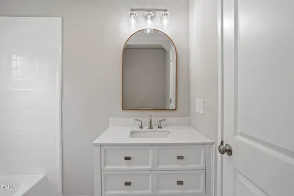 a bathroom with a sink a vanity and a mirror