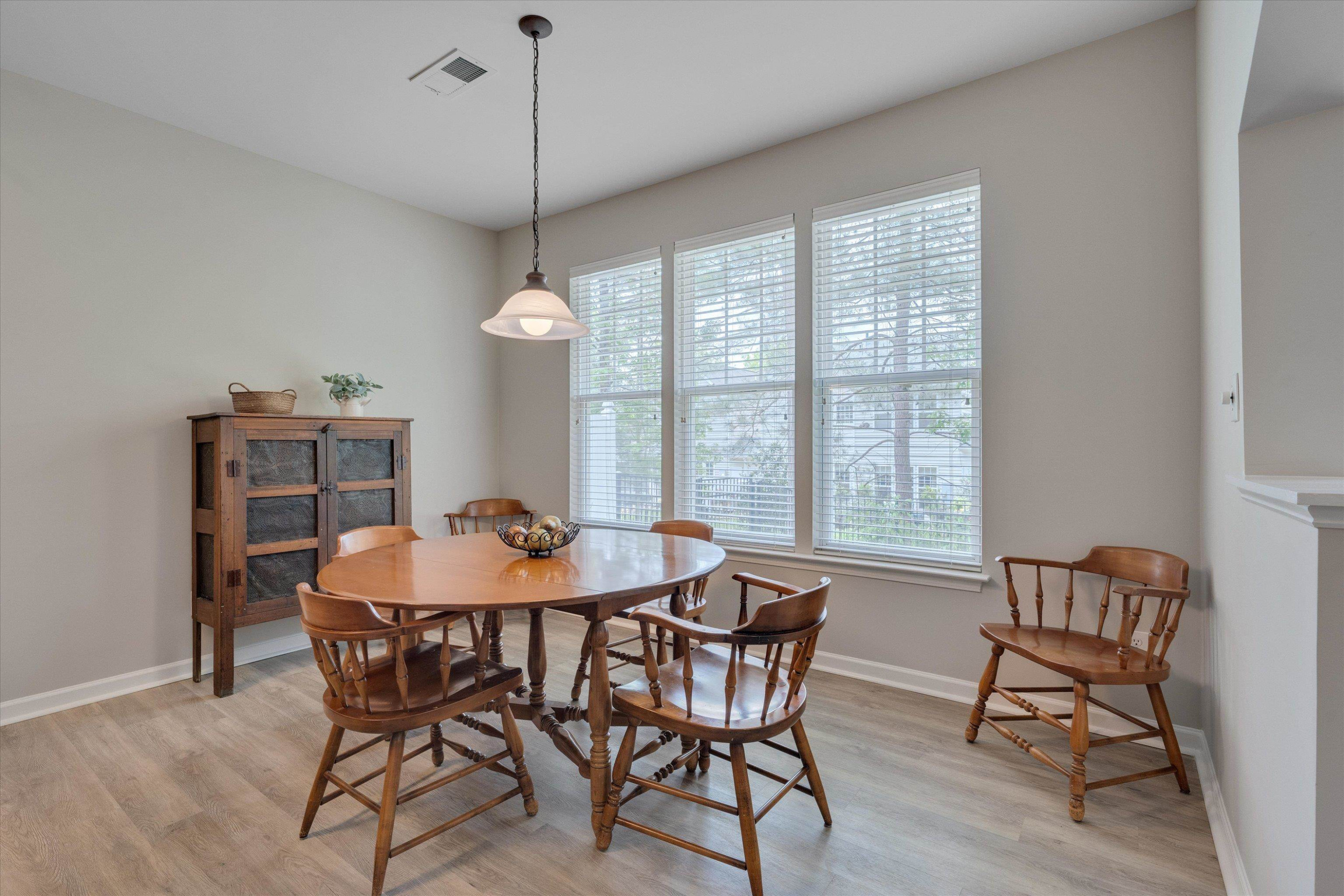 5 Gardenview Place Durham, NC 27713 - Photo 12 of 32 a dining room with furniture a chandelier and wooden floor