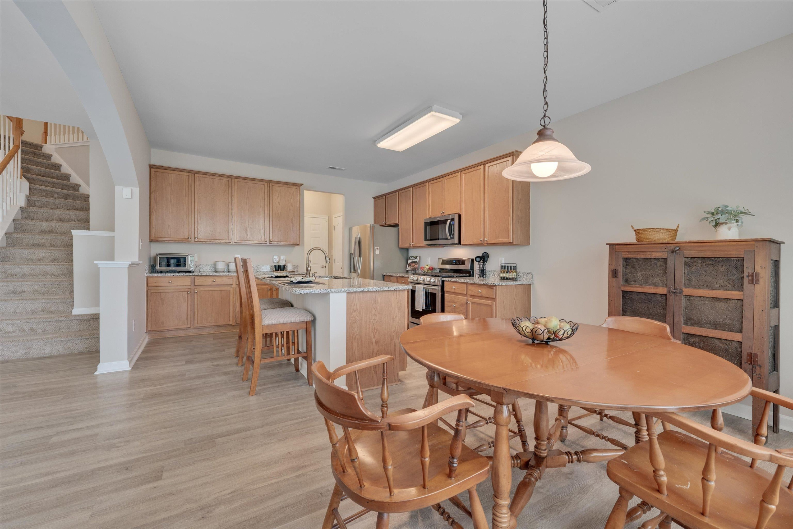 5 Gardenview Place Durham, NC 27713 - Photo 13 of 32 a kitchen with a dining table chairs and white cabinets