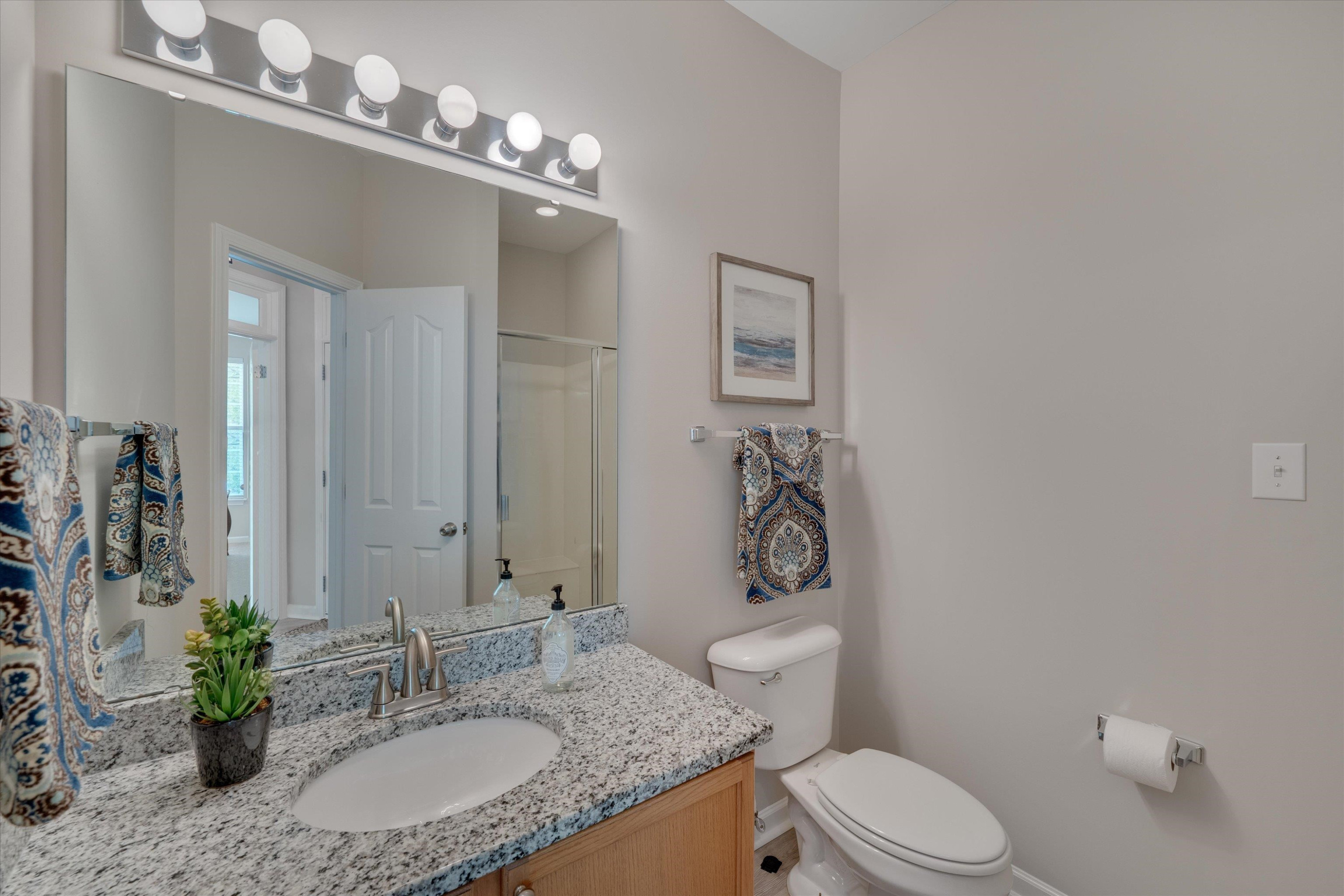5 Gardenview Place Durham, NC 27713 - Photo 16 of 32 a bathroom with a granite countertop sink vanity mirror and toilet