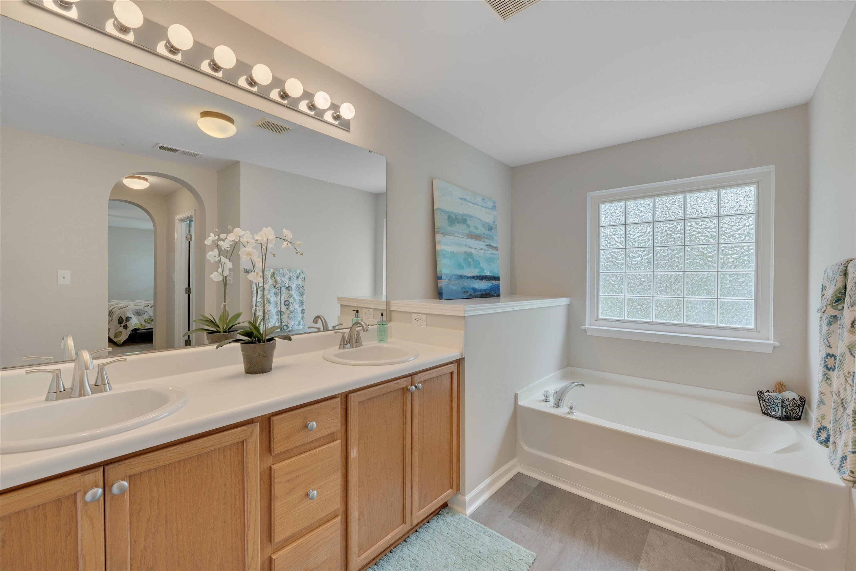 5 Gardenview Place Durham, NC 27713 - Photo 21 of 32 a bathroom with a tub a double vanity sink and mirror