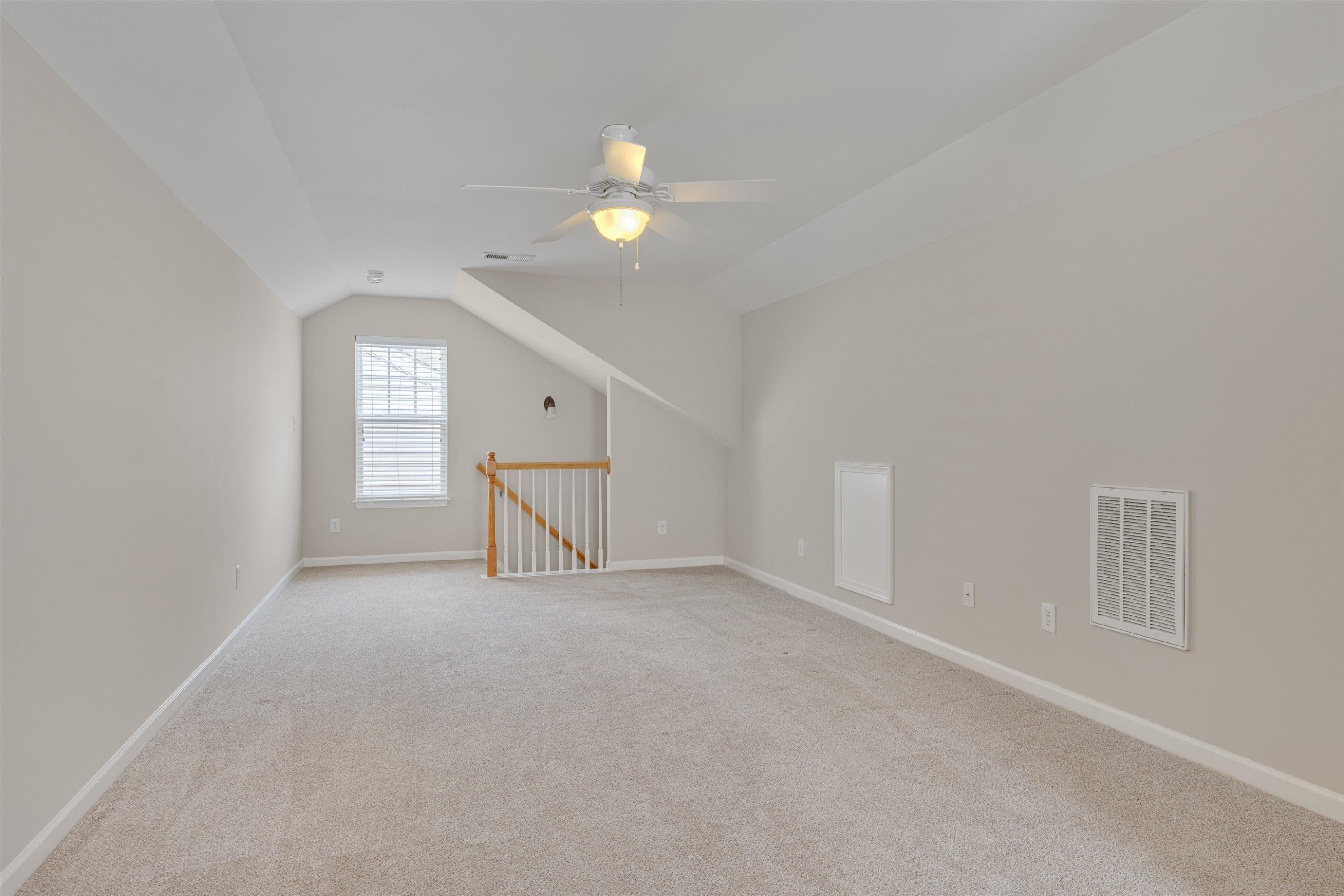 5 Gardenview Place Durham, NC 27713 - Photo 28 of 32 an empty room with a chandelier fan and windows