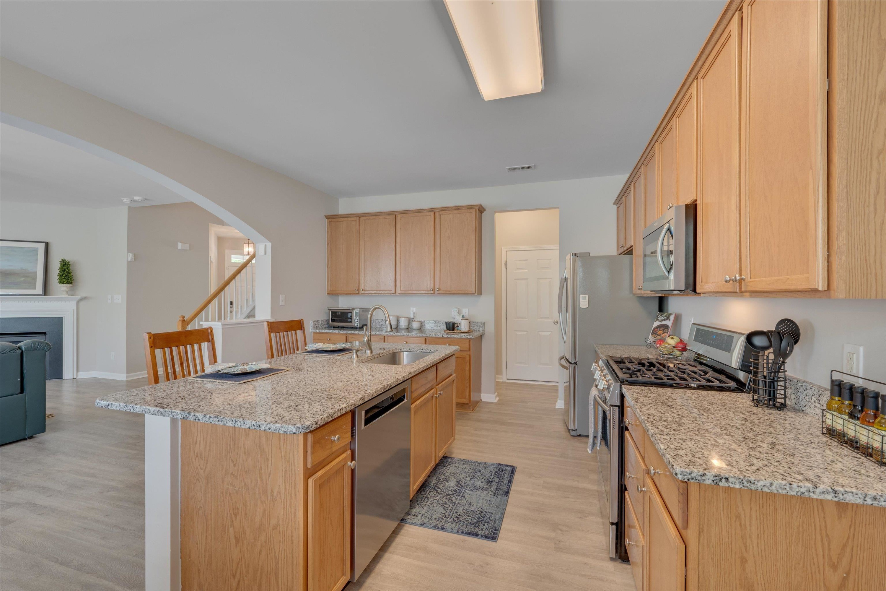5 Gardenview Place Durham, NC 27713 - Photo 8 of 32 a kitchen with stainless steel appliances granite countertop a sink stove and refrigerator
