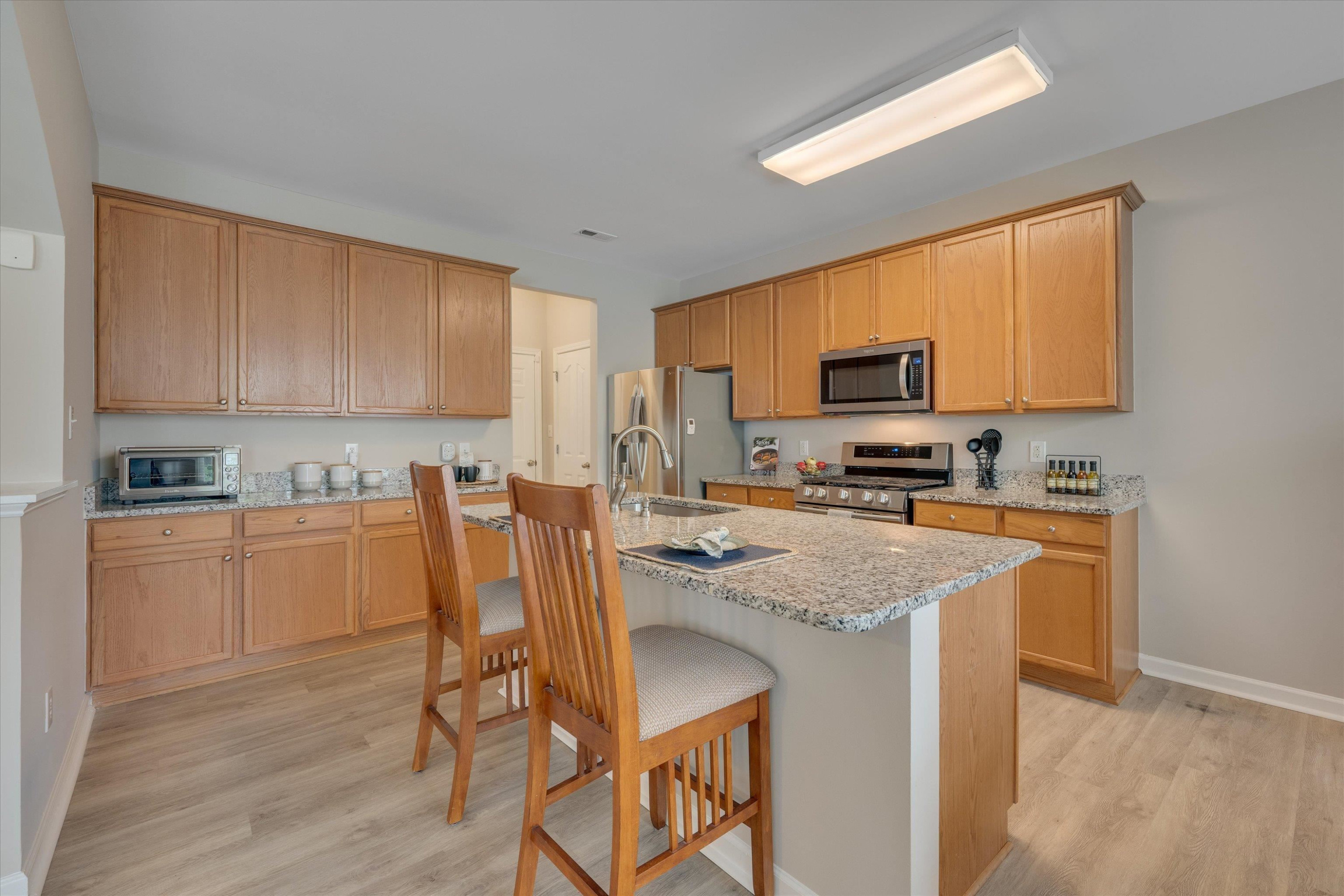 5 Gardenview Place Durham, NC 27713 - Photo 9 of 32 a kitchen with a stove a sink a microwave and cabinets