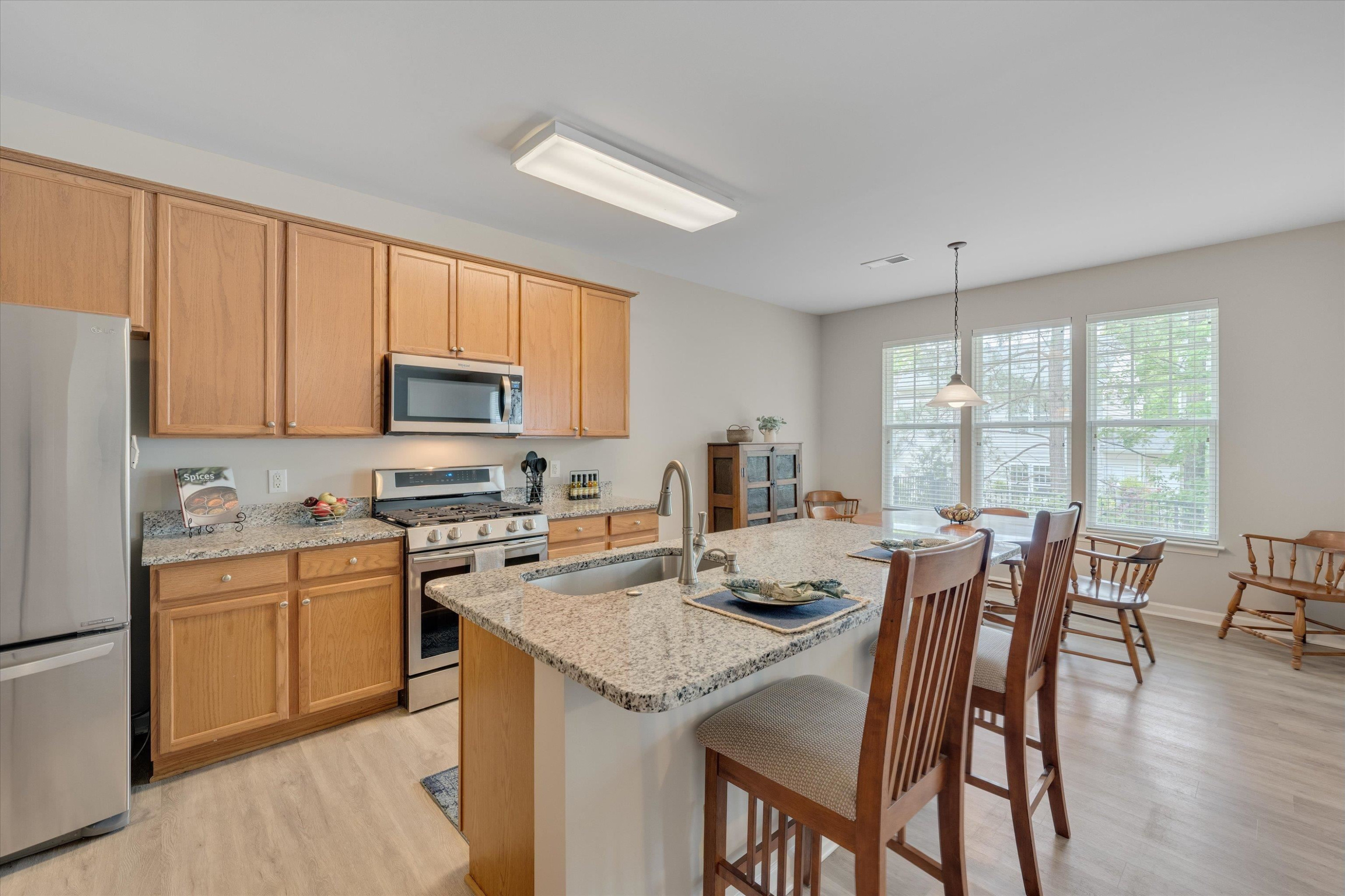 5 Gardenview Place Durham, NC 27713 - Photo 10 of 32 a view of kitchen with granite countertop stove top oven dining table and chairs