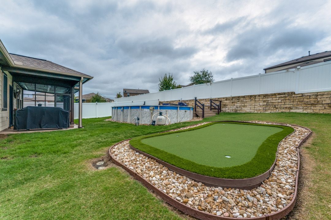 5921 Lehman Way Austin, TX 78747 - Photo 23 of 25 A private yard offers a dedicated putting green and an above-ground pool for leisure and recreation.