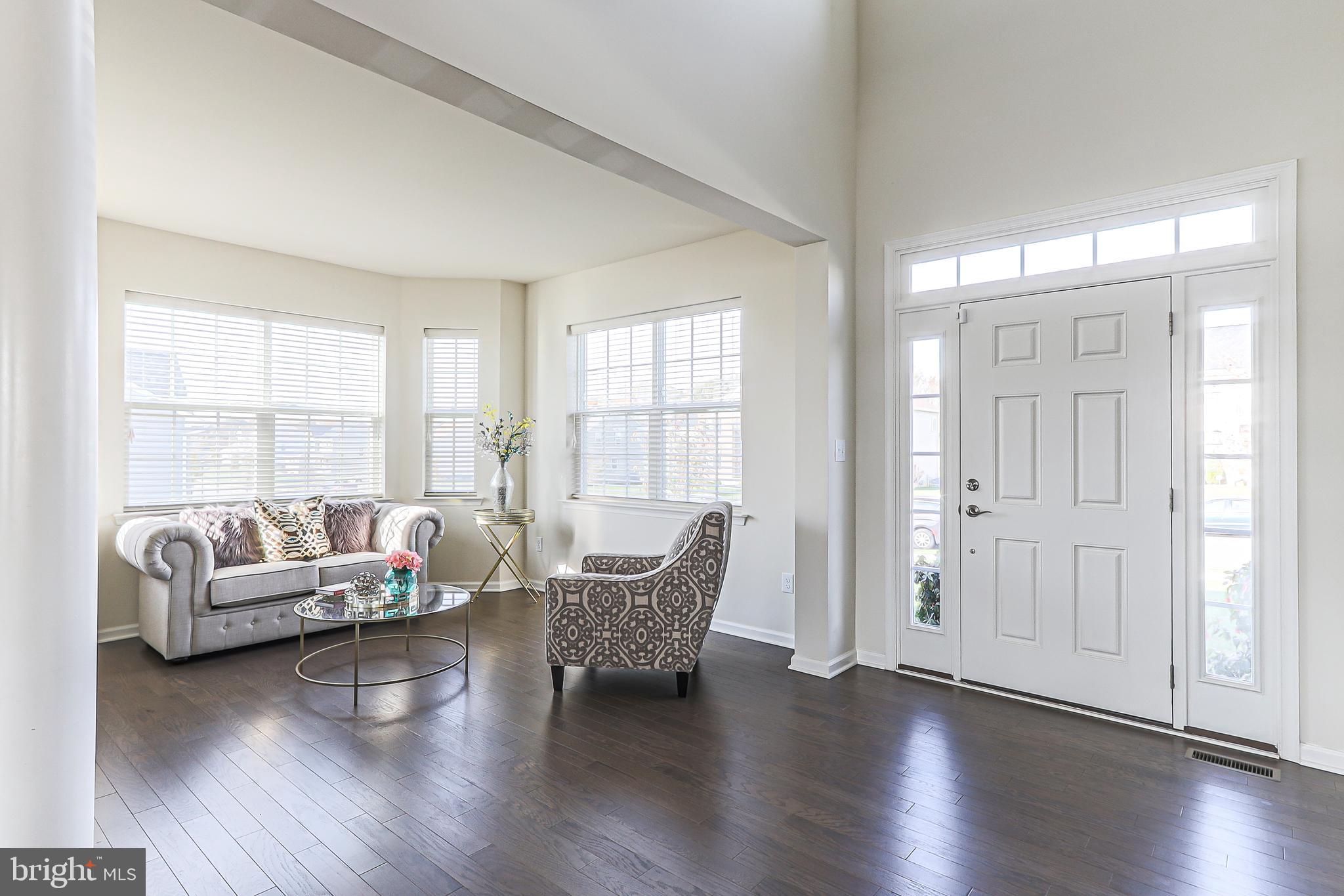Into the spacious two story foyer into living room