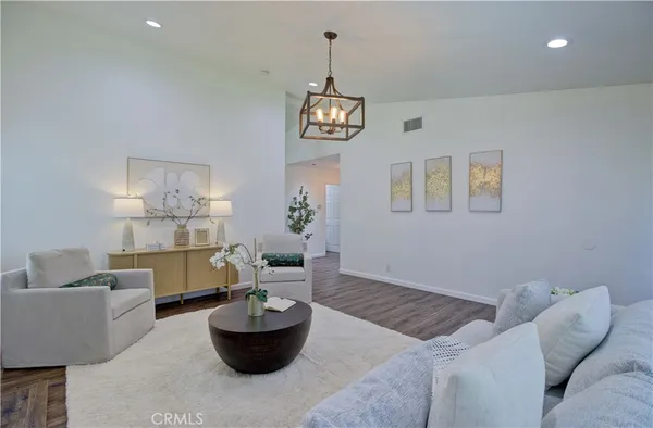 a living room with furniture and a potted plant