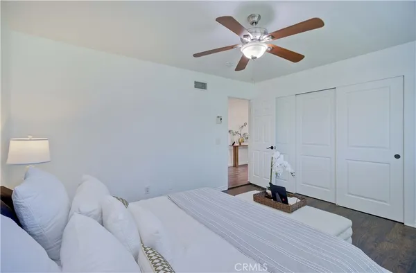a bedroom with a bed and a ceiling fan
