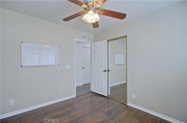 an empty room with fan and a ceiling fan