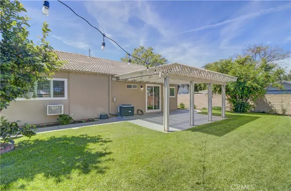 a view of a house with a yard and sitting area