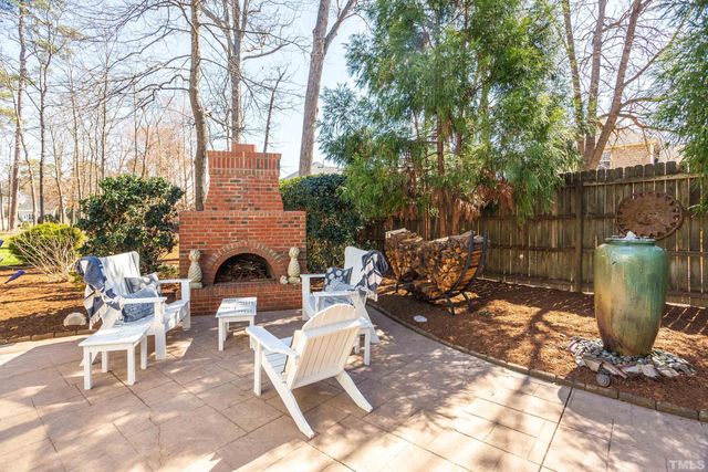 a view of a patio with a table and chairs under an umbrella
