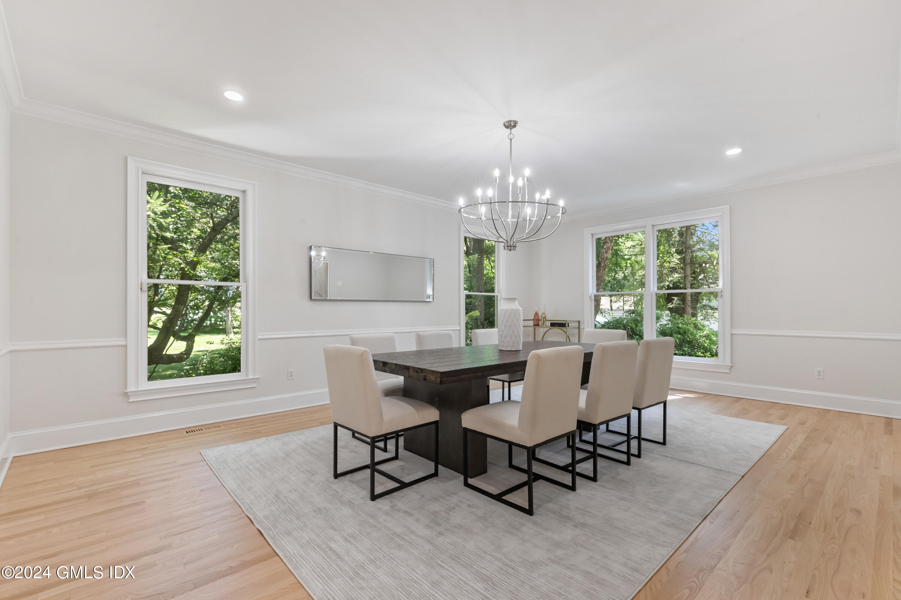 107 Summit Road Riverside, CT 06878 - Photo 13 of 47 a view of a dining room with furniture a chandelier and wooden floor