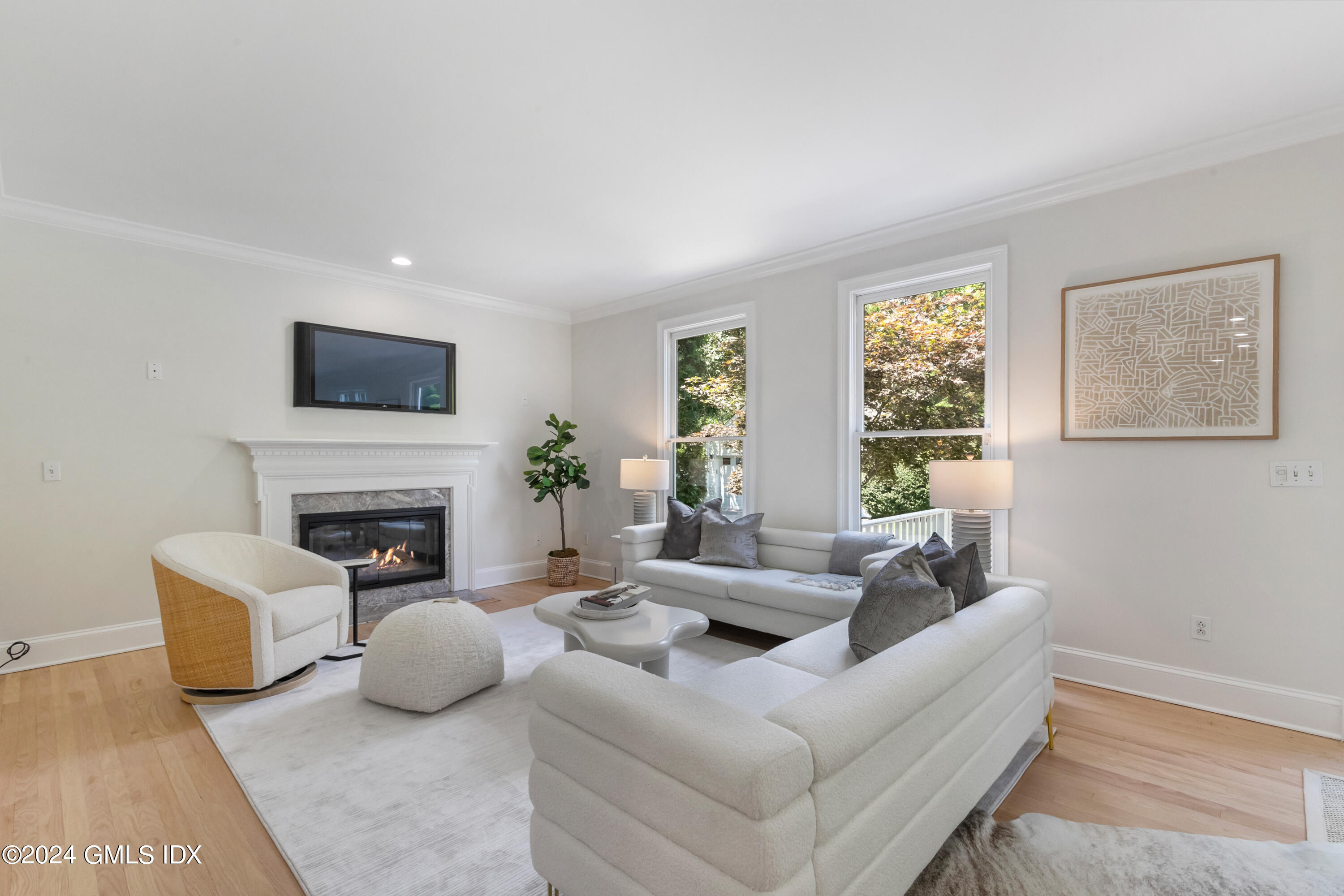 107 Summit Road Riverside, CT 06878 - Photo 22 of 47 a living room with furniture a fireplace and a flat screen tv