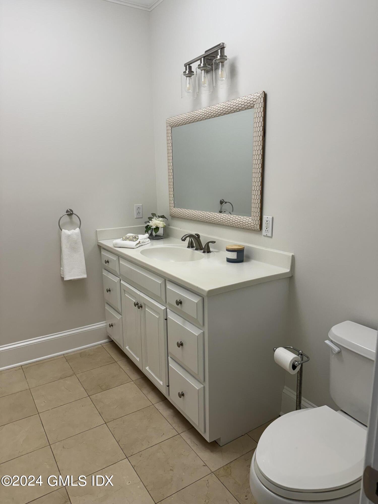 107 Summit Road Riverside, CT 06878 - Photo 26 of 47 a bathroom with a sink a toilet and mirror