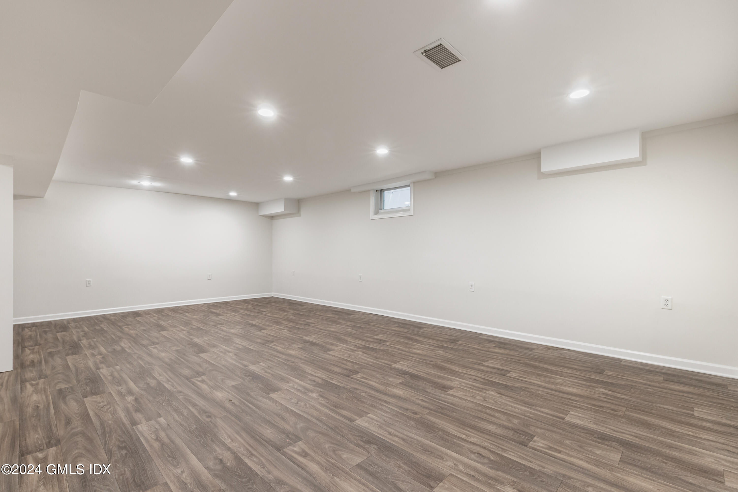 107 Summit Road Riverside, CT 06878 - Photo 34 of 47 an empty room with wooden floor and windows