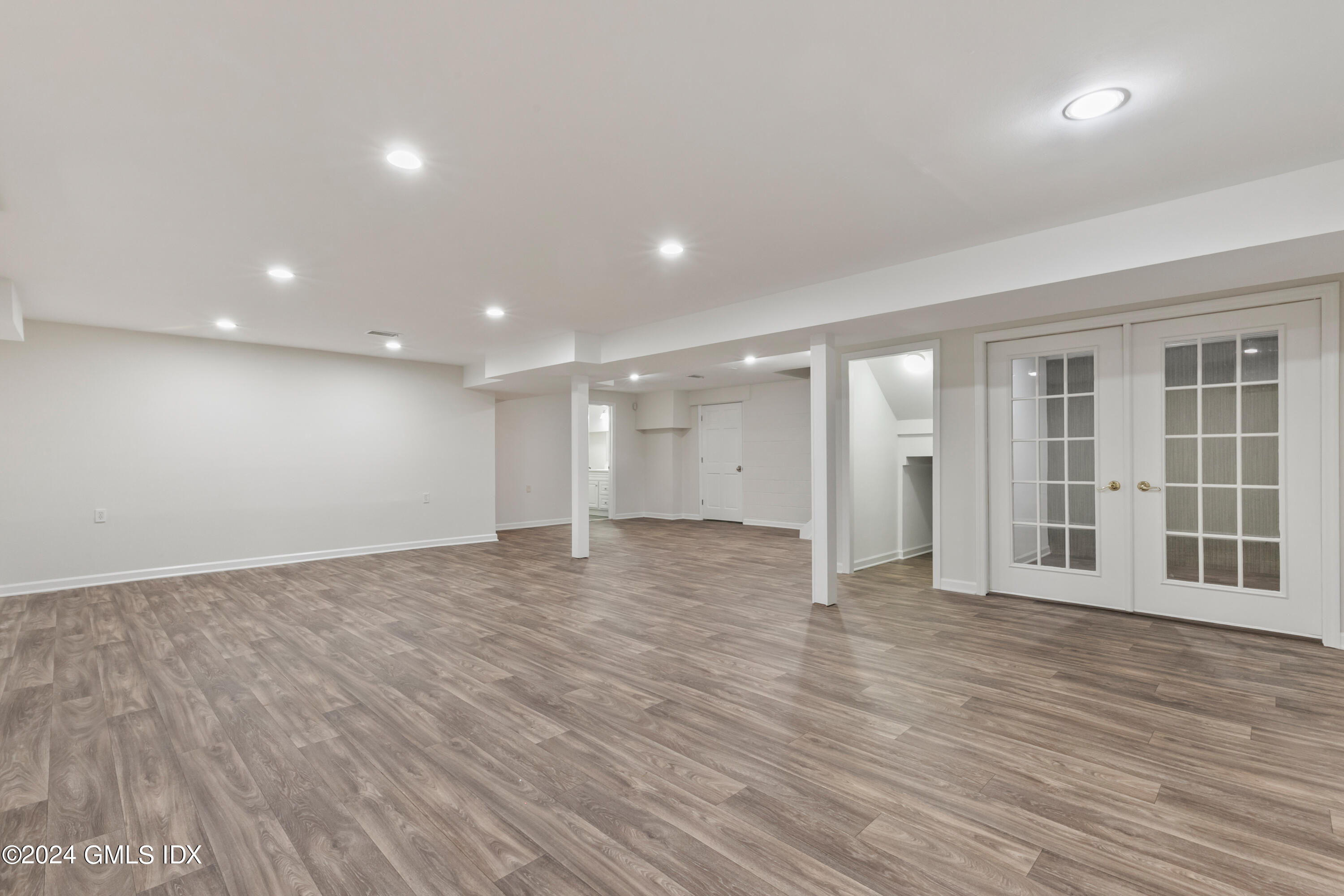 107 Summit Road Riverside, CT 06878 - Photo 35 of 47 a view of an empty room with wooden floor and windows
