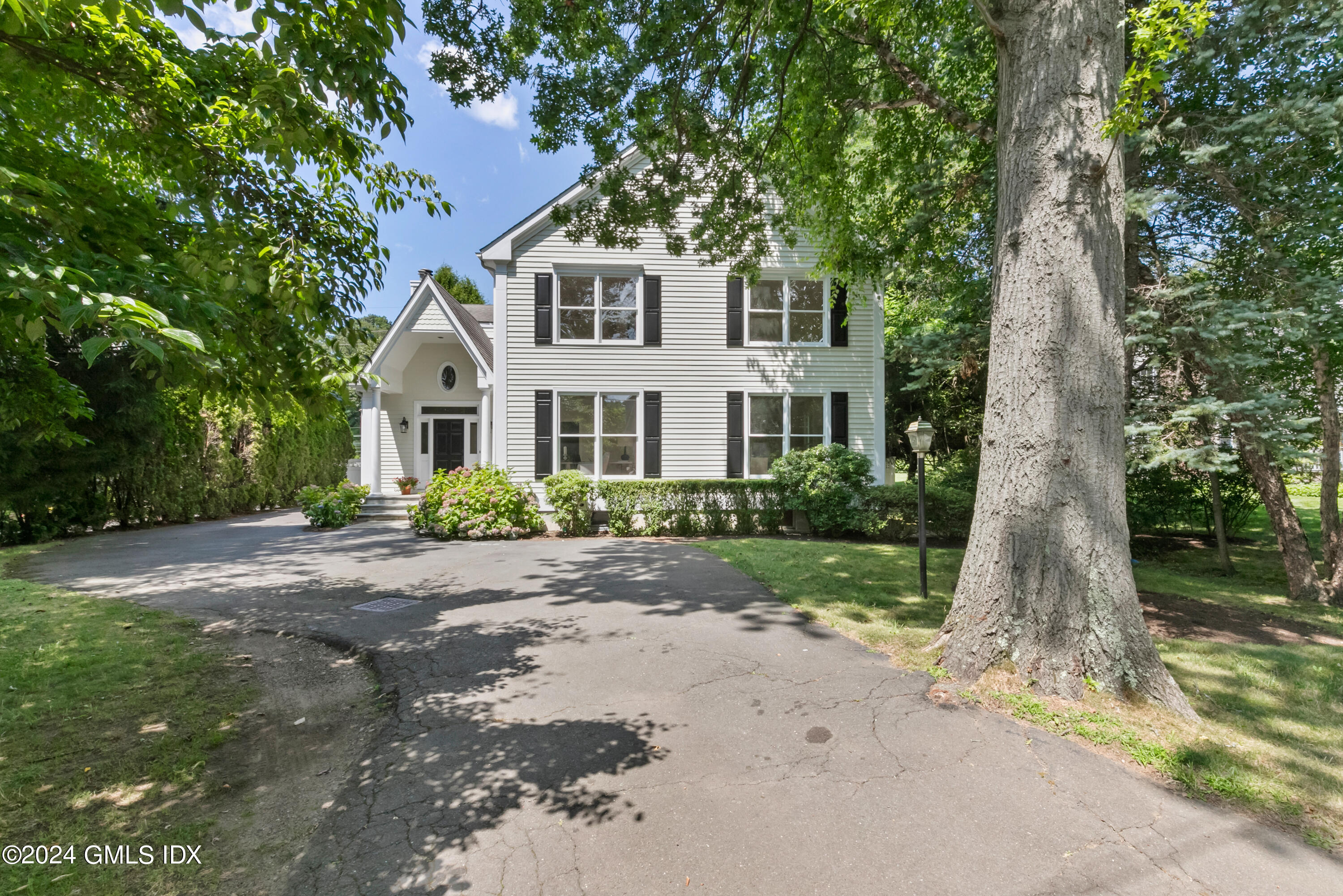 107 Summit Road Riverside, CT 06878 - Photo 4 of 47 a front view of a house with a garden
