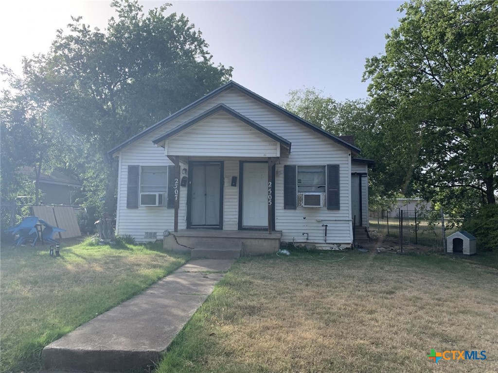 a view of a house with a yard