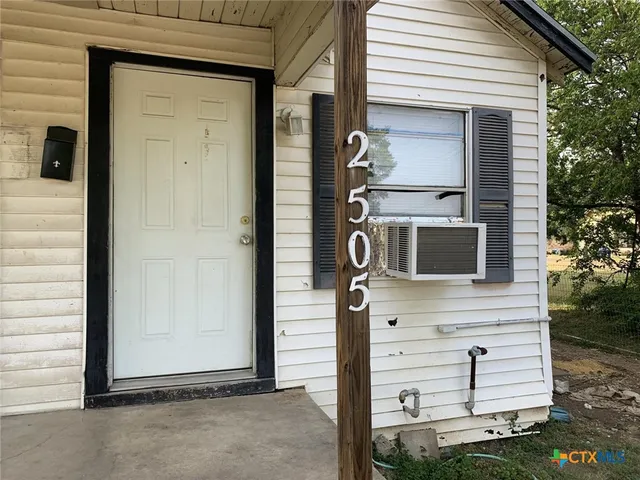 a view of front door and potted plants