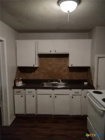a kitchen with a sink and cabinets