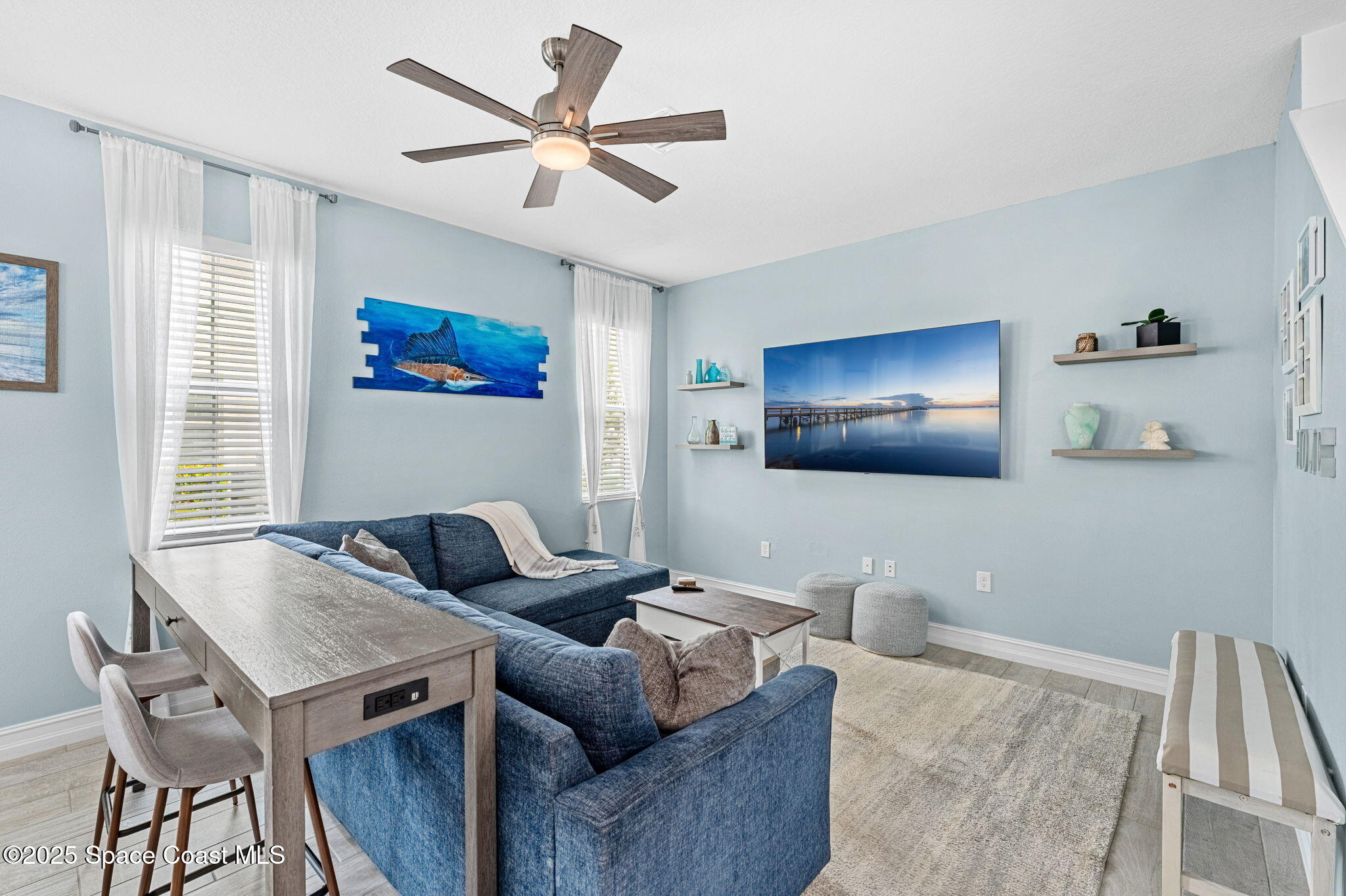 1810 Noel Place, Unit 107 Melbourne, FL 32935 - Photo 11 of 59 a living room with furniture and a flat screen tv