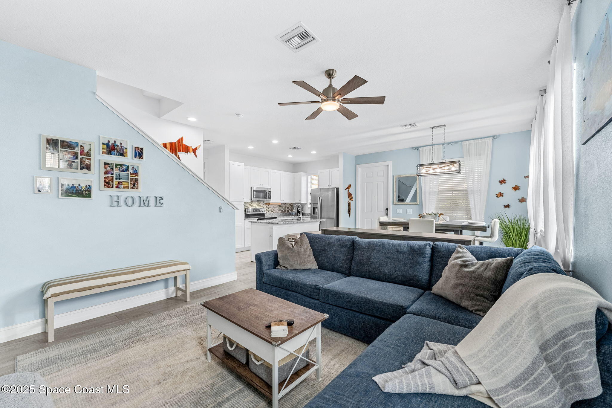 1810 Noel Place, Unit 107 Melbourne, FL 32935 - Photo 13 of 59 a living room with furniture and a ceiling fan