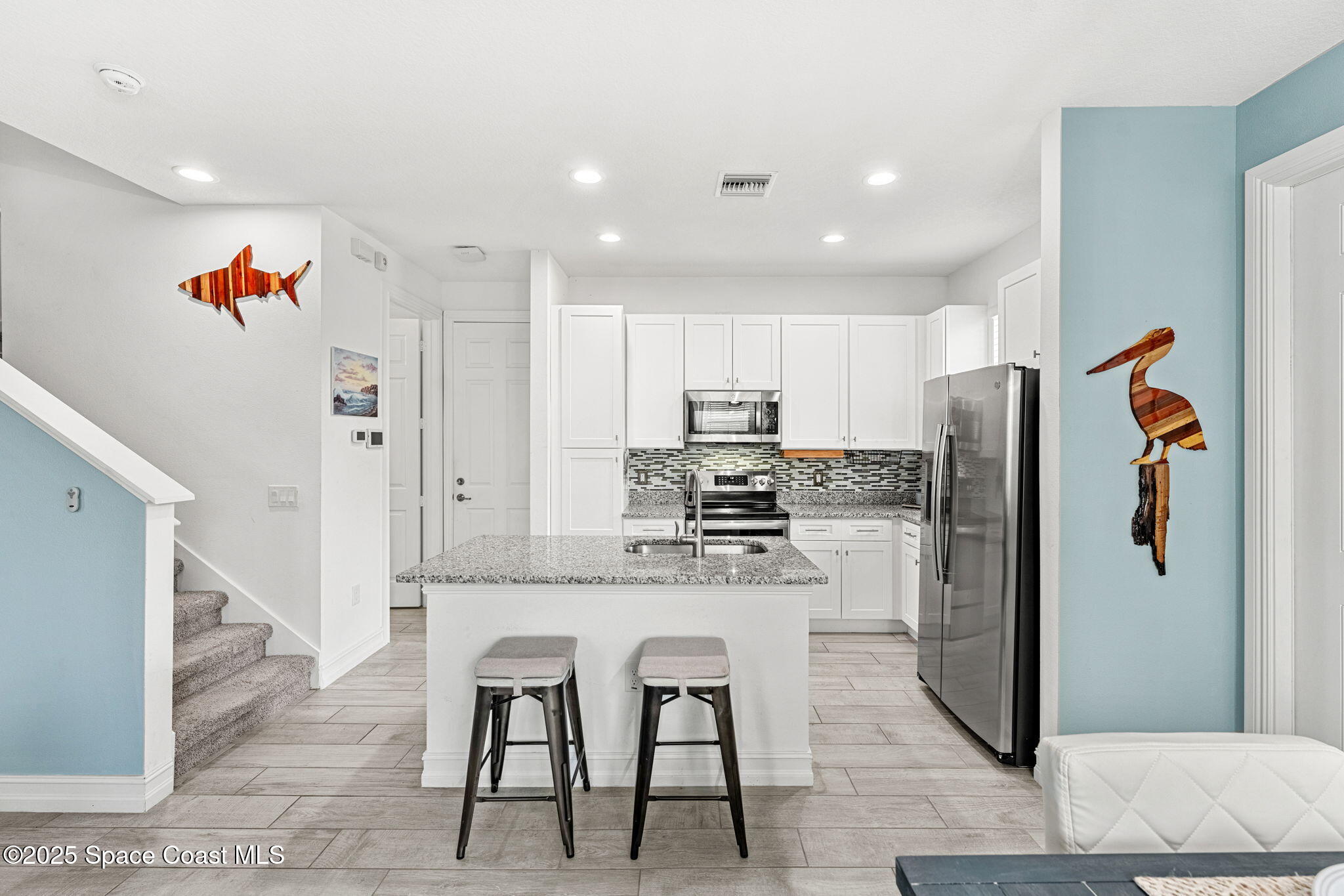 1810 Noel Place, Unit 107 Melbourne, FL 32935 - Photo 16 of 59 a kitchen with stainless steel appliances granite countertop a refrigerator and a stove top oven