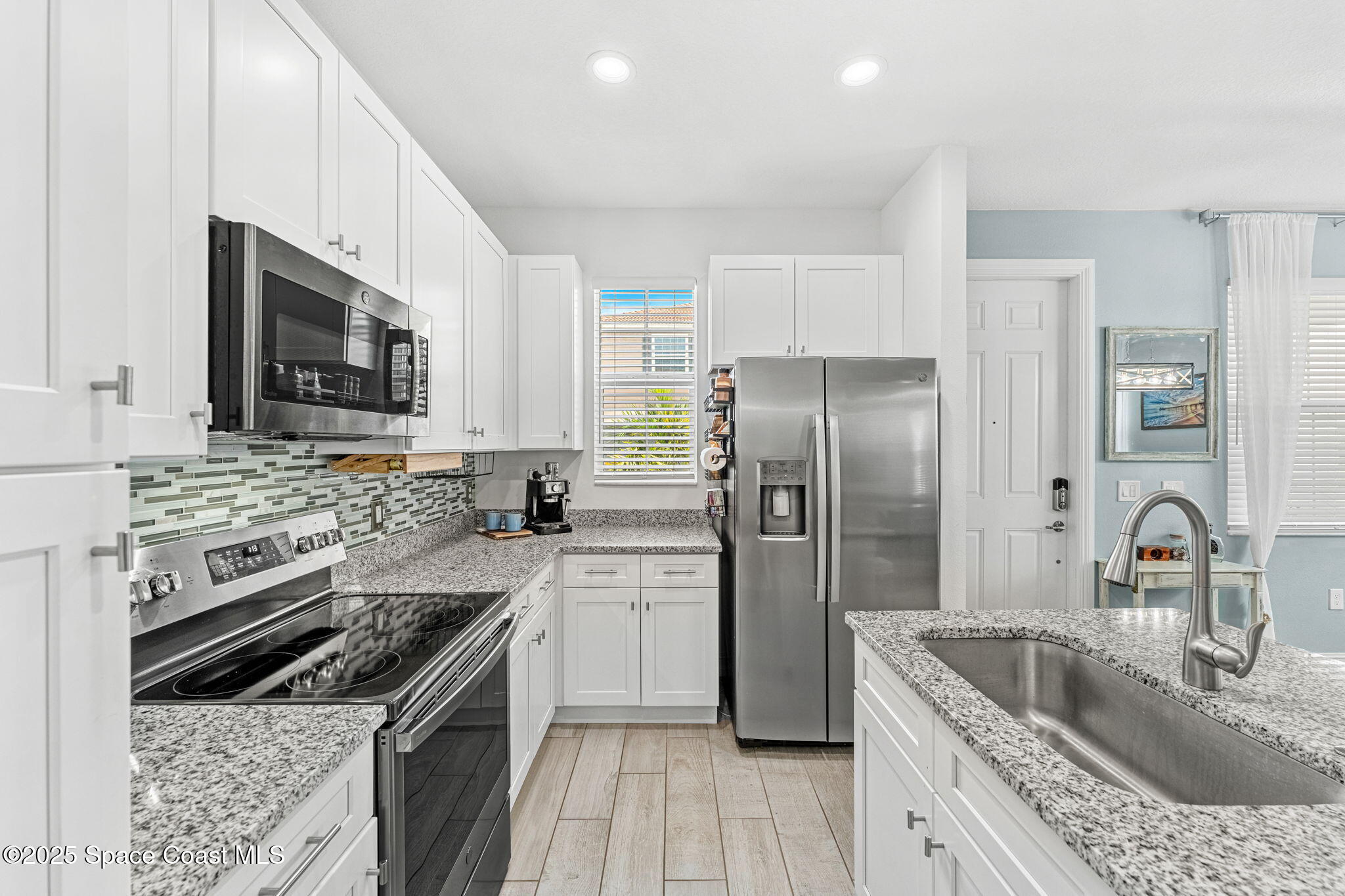 1810 Noel Place, Unit 107 Melbourne, FL 32935 - Photo 19 of 59 a kitchen with a stove sink and refrigerator