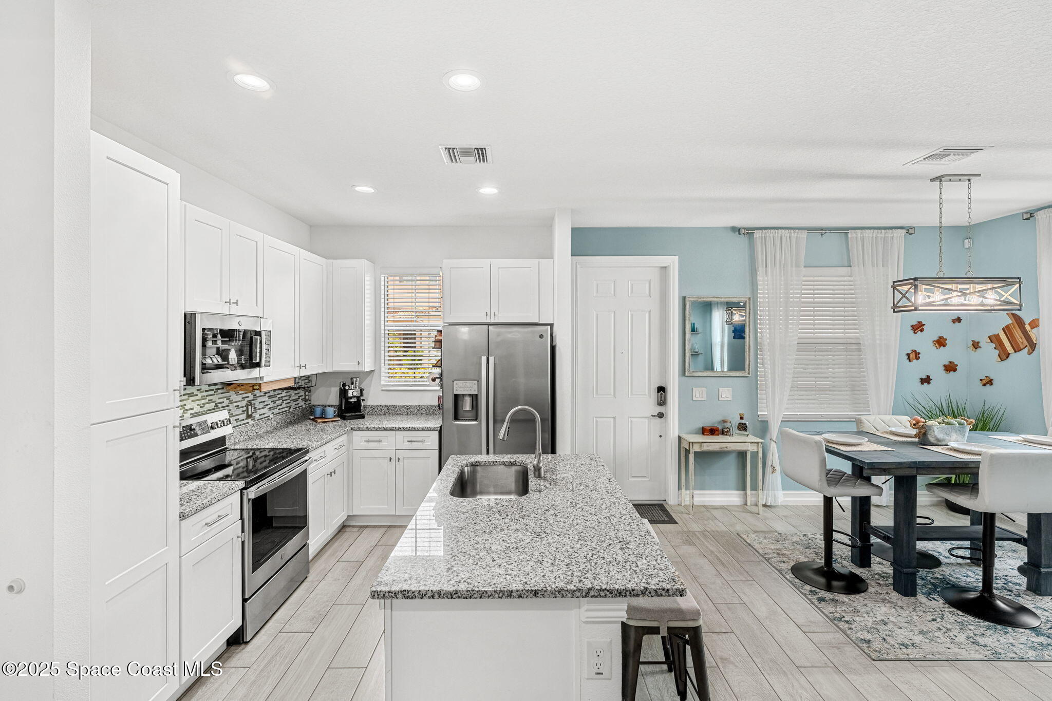 1810 Noel Place, Unit 107 Melbourne, FL 32935 - Photo 21 of 59 a kitchen with stainless steel appliances granite countertop a stove refrigerator and a sink
