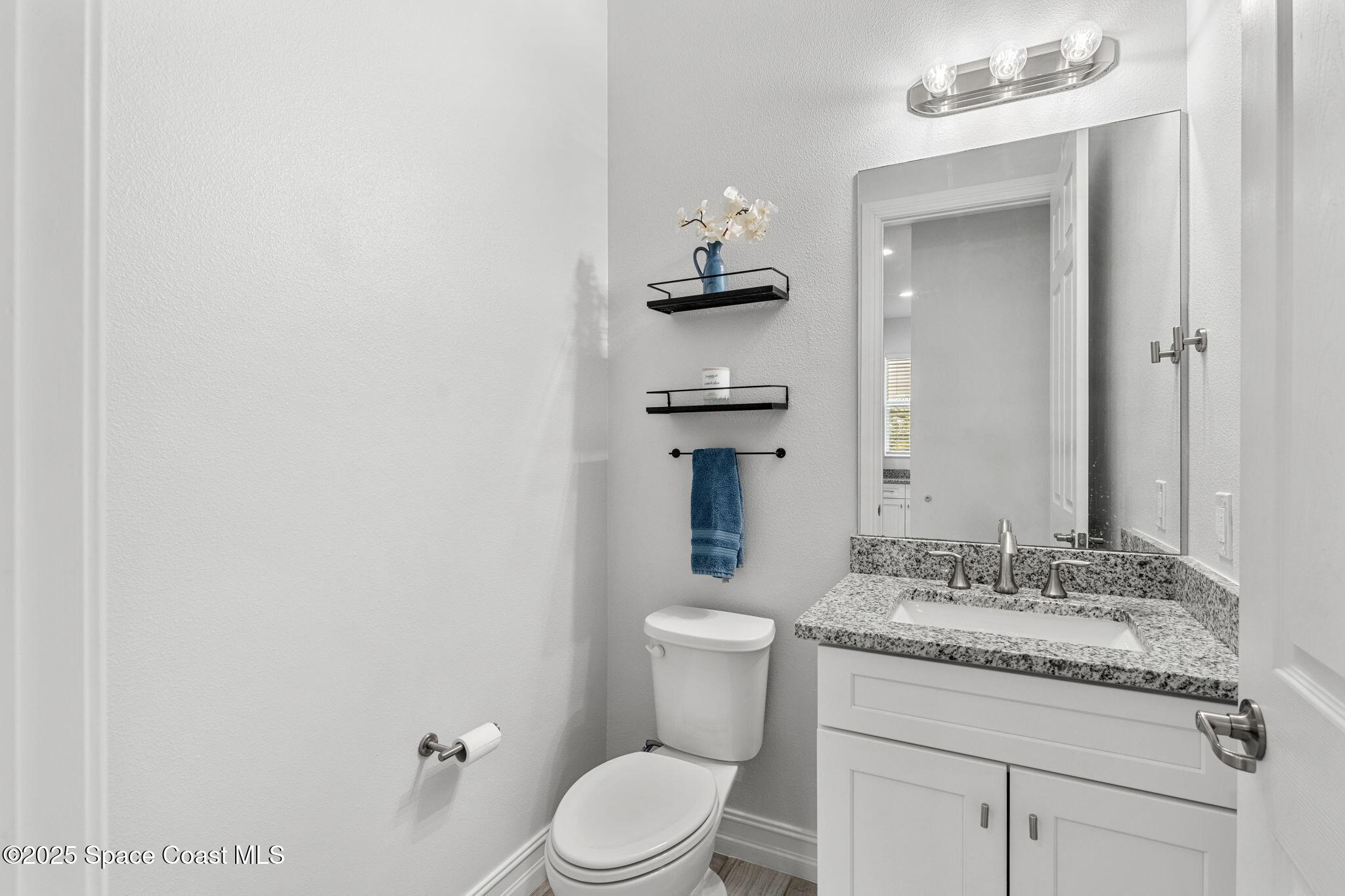1810 Noel Place, Unit 107 Melbourne, FL 32935 - Photo 24 of 59 a bathroom with a granite countertop sink toilet and mirror