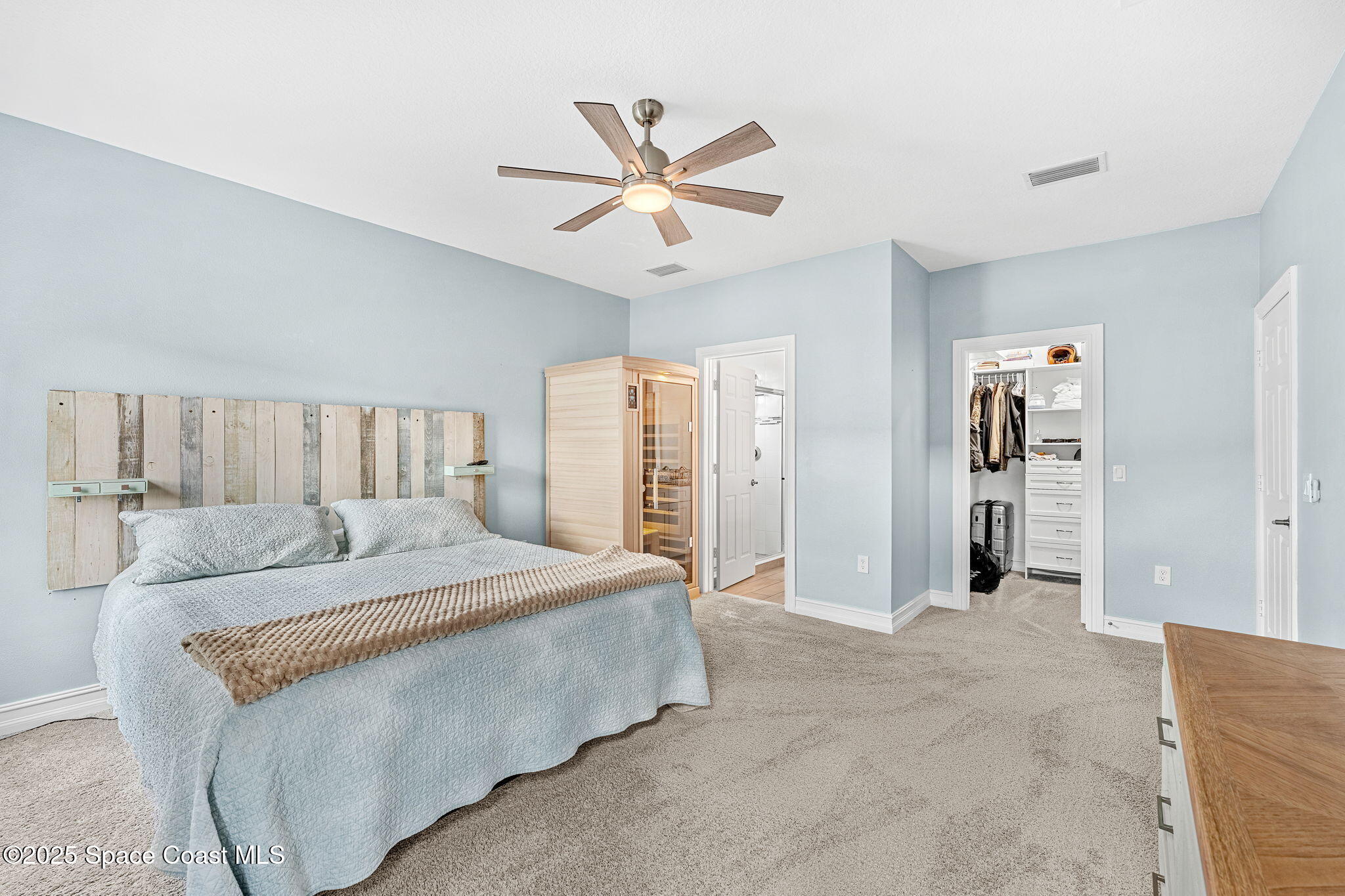1810 Noel Place, Unit 107 Melbourne, FL 32935 - Photo 28 of 59 a bedroom with a large bed and ceiling fan