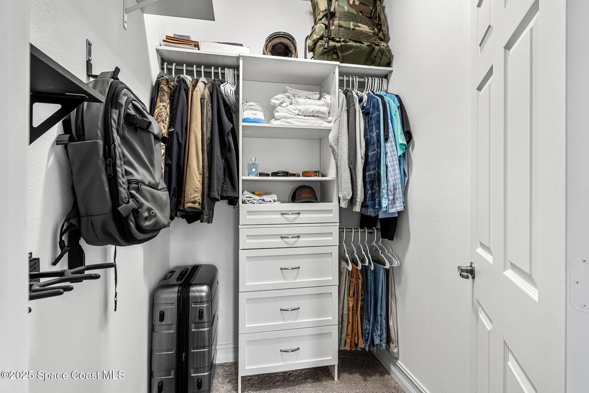 1810 Noel Place, Unit 107 Melbourne, FL 32935 - Photo 31 of 59 a view of walk in closet with clothes and shoes