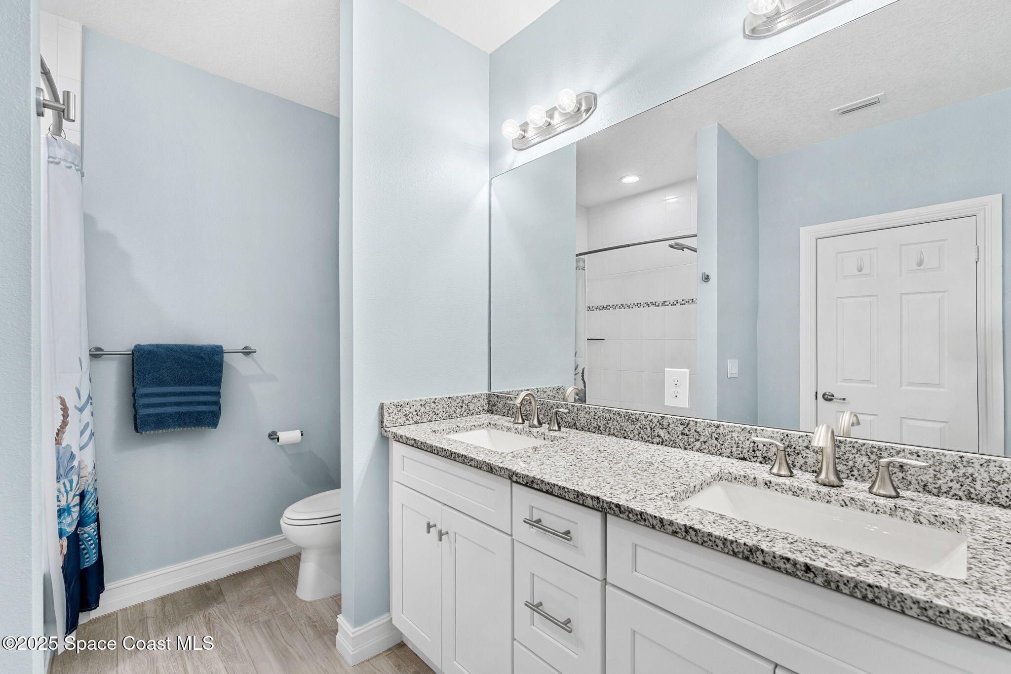1810 Noel Place, Unit 107 Melbourne, FL 32935 - Photo 37 of 59 a bathroom with a granite countertop double vanity sink mirror and toilet