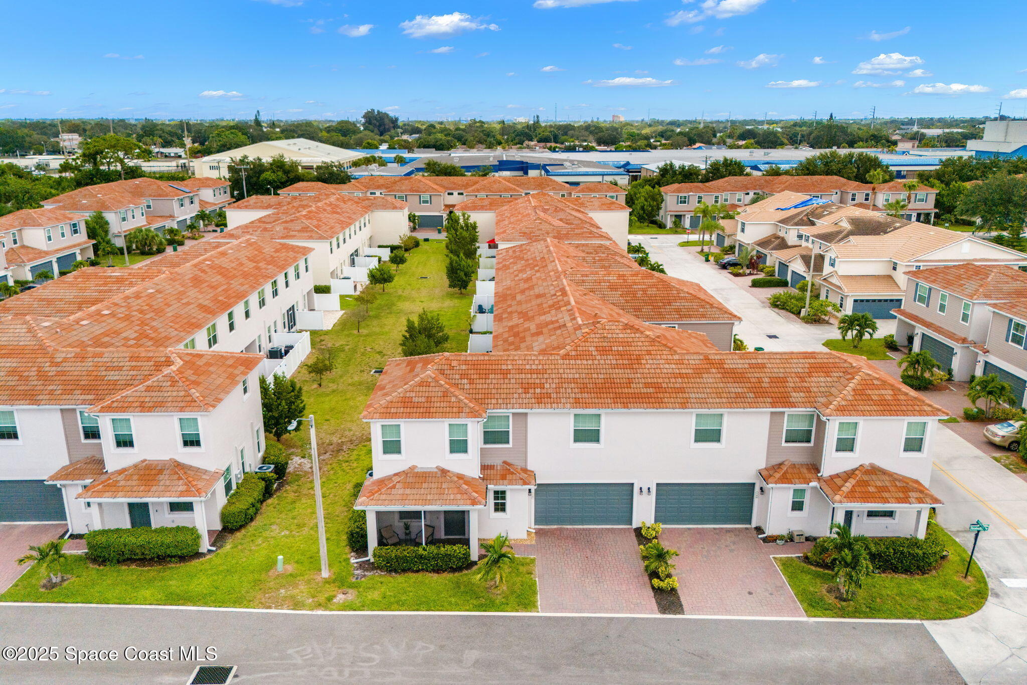 1810 Noel Place, Unit 107 Melbourne, FL 32935 - Photo 46 of 59 an aerial view of multiple houses with a lake