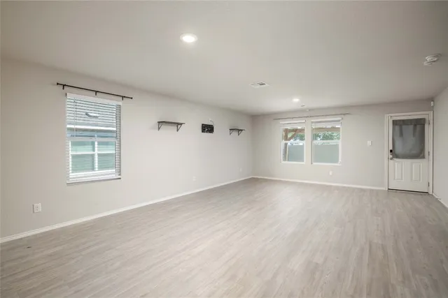 a view of kitchen with kitchen island and stainless steel appliances