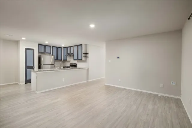 a view of a kitchen with kitchen island granite countertop a sink and dishwasher