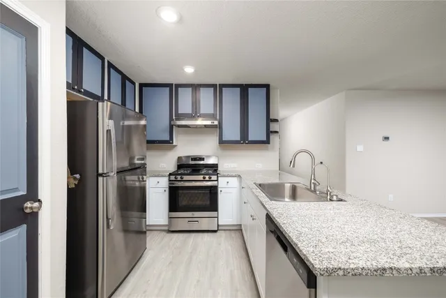 a kitchen with granite countertop a sink and a granite counter tops