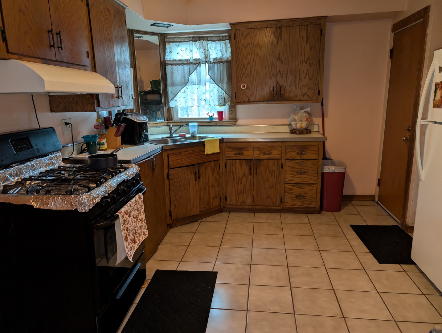 920 Augusta Avenue Elgin, IL 60120 - Photo 13 of 16 a kitchen with a sink a stove and a microwave