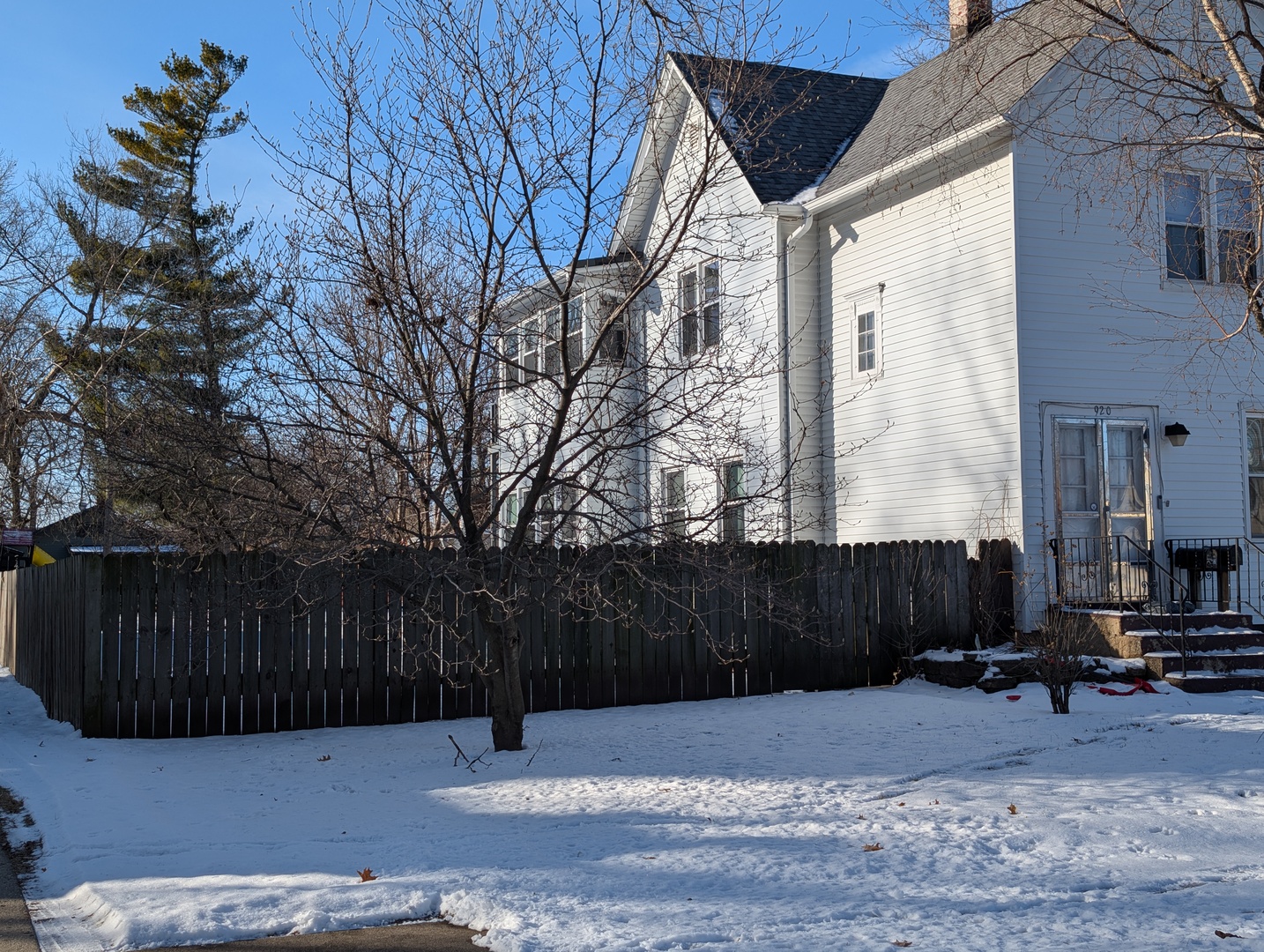920 Augusta Avenue Elgin, IL 60120 - Photo 4 of 16 a street view with wooden fence and plants