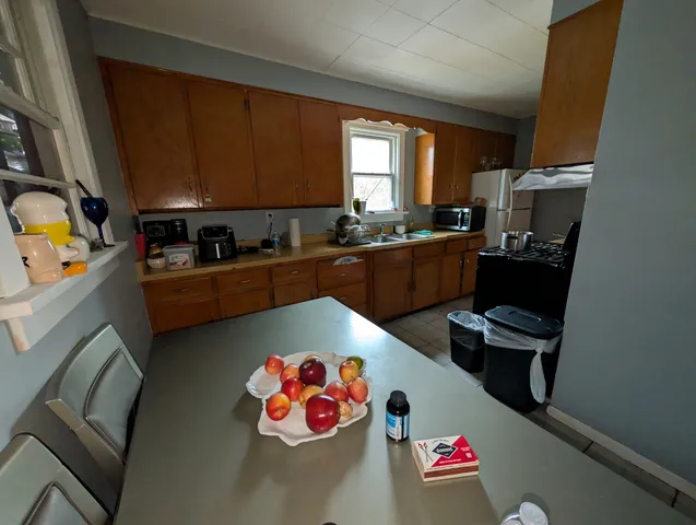 a kitchen with a refrigerator and a stove top oven