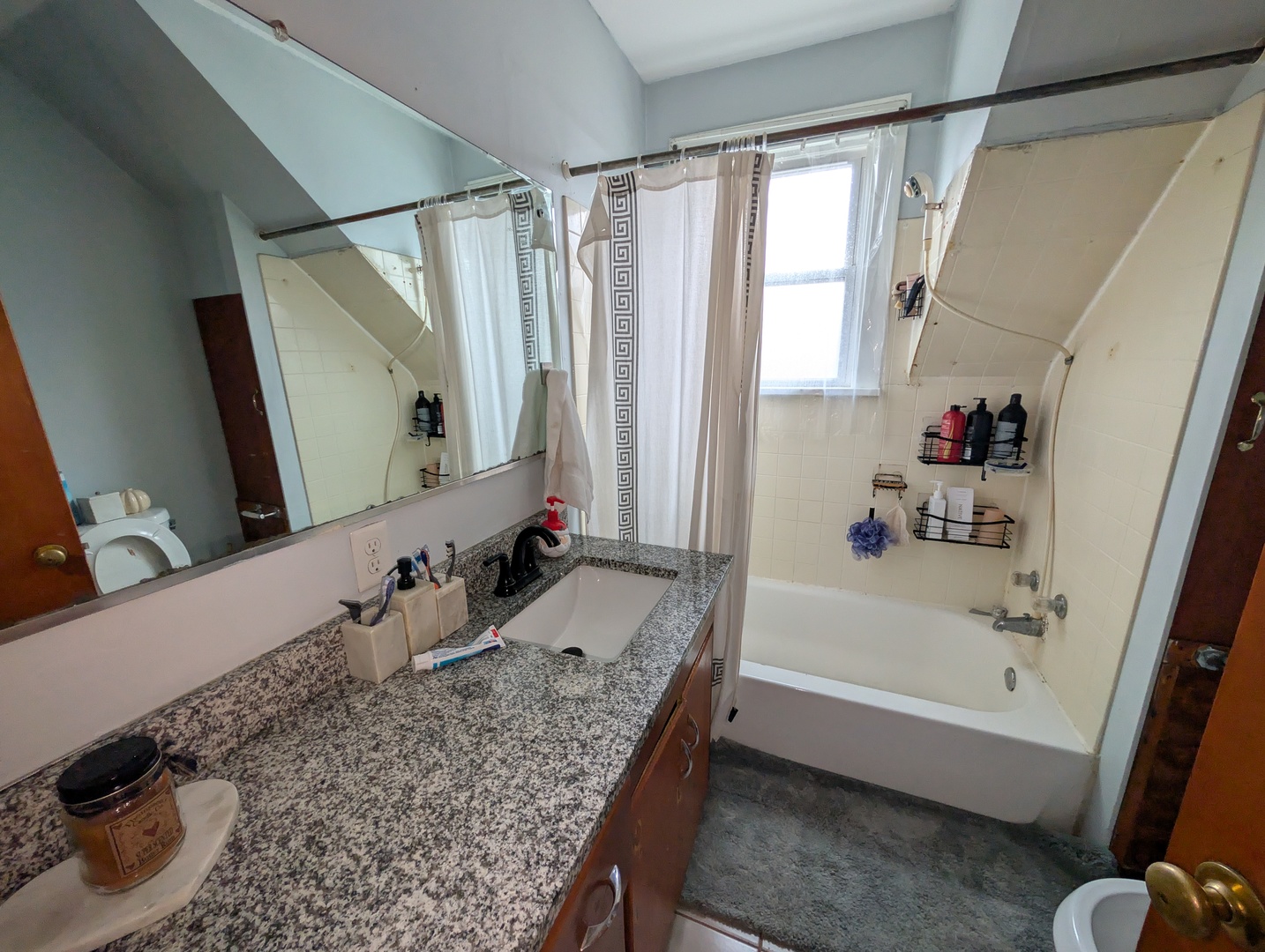920 Augusta Avenue Elgin, IL 60120 - Photo 8 of 16 a bathroom with a tub sink and mirror