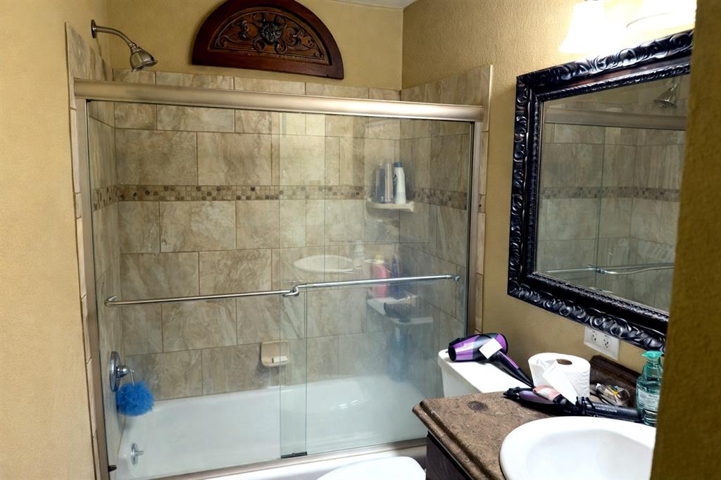 1525 Mansfield Road Reno, TX 75462 - Photo 34 of 34 a bathroom with a toilet a sink and shower