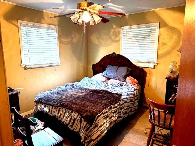 1525 Mansfield Road Reno, TX 75462 - Photo 10 of 34 a bedroom with a bed and wooden floor